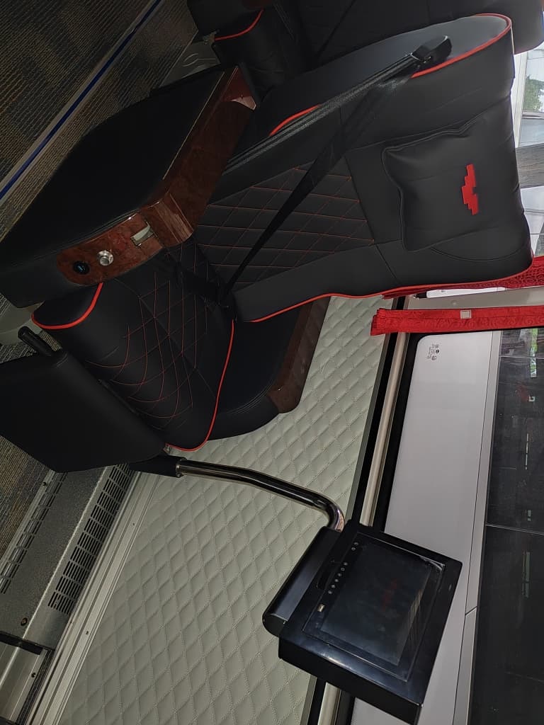 VIP seat detail with wood armrest and personal entertainment screen