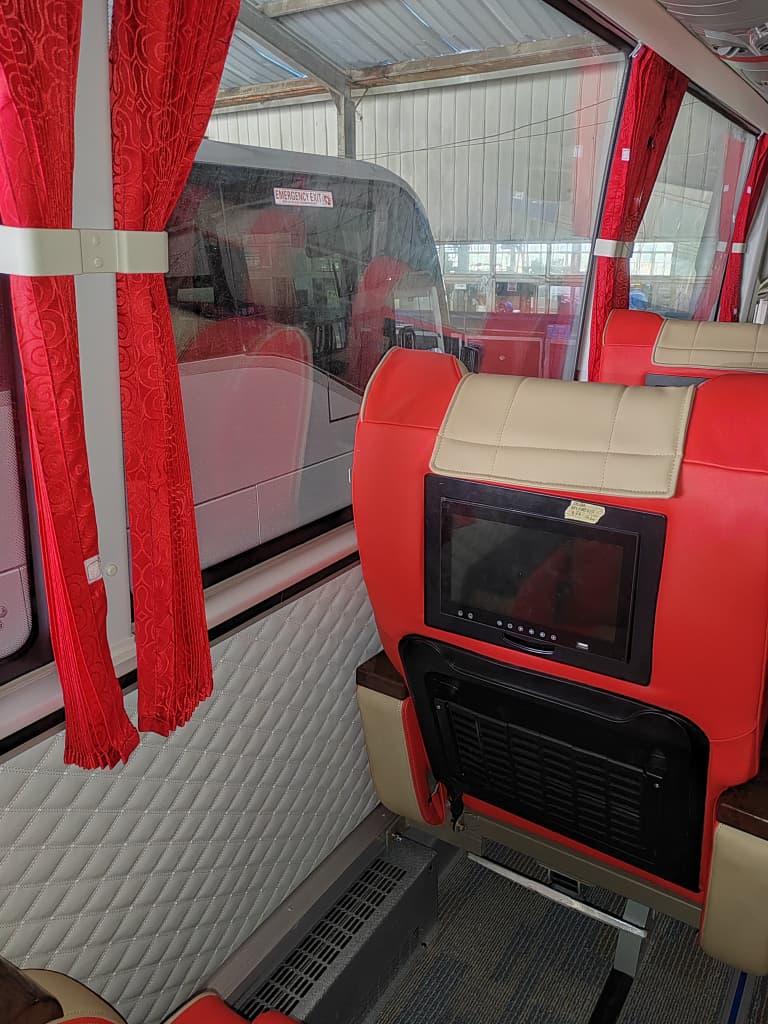 Passenger seat / window detail — red & beige interior