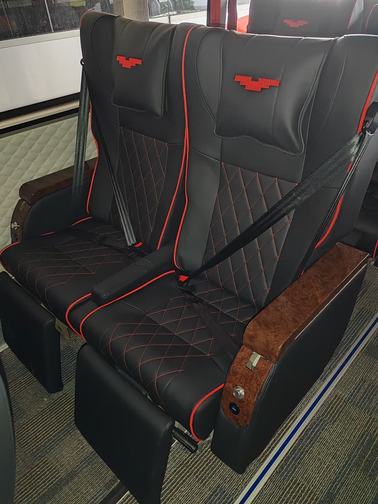 Passenger seat / window detail — red & beige interior